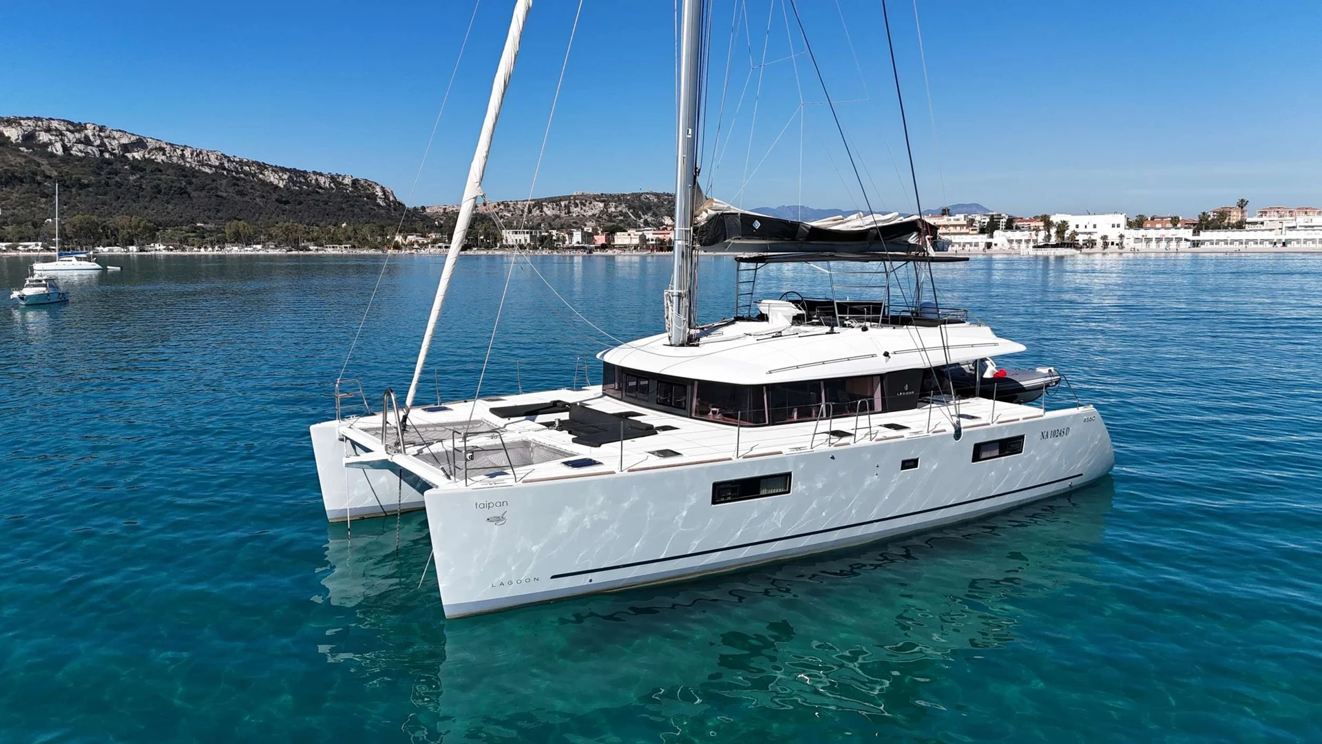 Luxury catamaran anchored in clear water