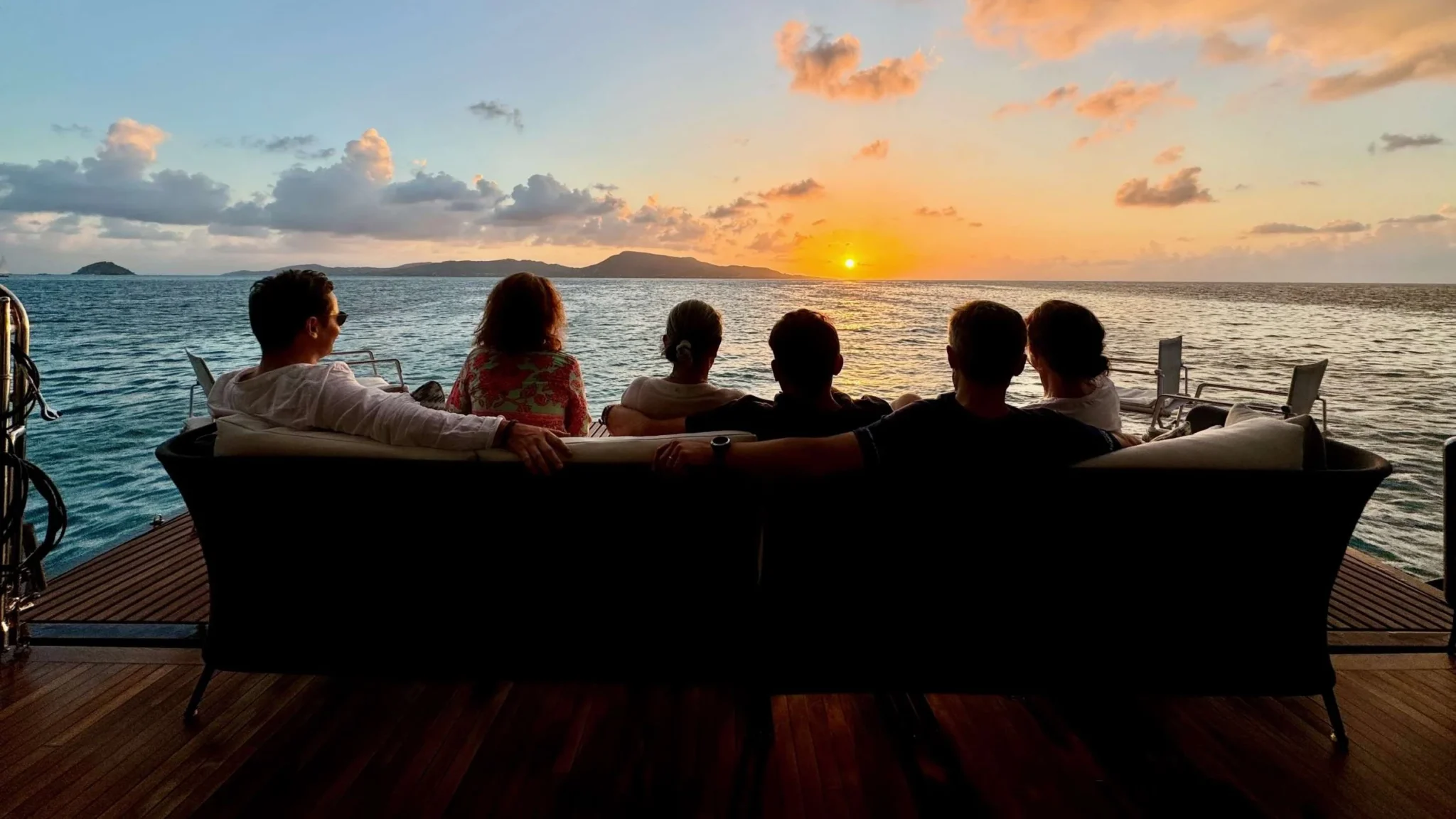 Group watching sunset over ocean